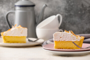 Plate with piece of tasty coconut pie on grey background