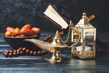 Aladdin lamp of wishes and Muslim lamp on dark wooden background