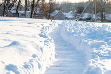 winter emergency: deep trench-trail in the snow, dug for the passage of people after heavy snowfall