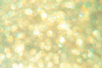 bright glitter background: bokeh effect from many colored lights on frozen glass, toning