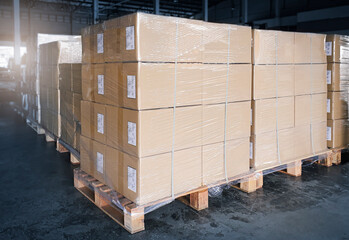 Stacked of cardboard boxes wrapped plastic on pallet rack. Interior of storage warehouse. shipping warehouse logistics. industry cargo export- import.	
