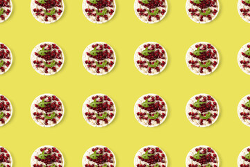 Abstract background from galett. Healthy breakfast with rice cake and pomegranate on black flat lay. Pop art