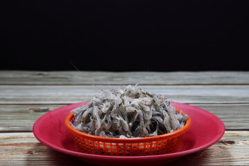Pile of fresh krill (small shrimp) in the plastic basket. Famous seafood ingredient in Asia restaurant. 