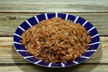 Pile of steamed krill (small shrimp) seasoning with sugar serving on the plate. Famous seafood...