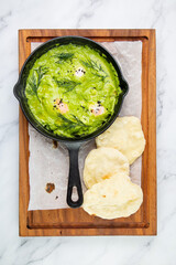 scrambled eggs with herbs, dill, celery and broccoli in a skillet with lean crispbread