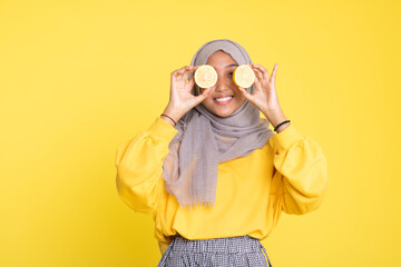 woman with orange on yellow background.