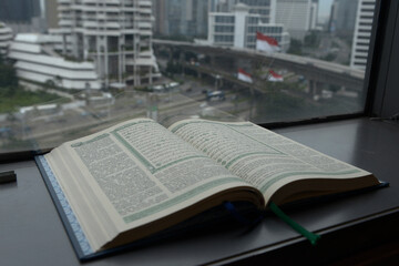 Quran open beside the window