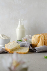 A loaf of wheat bread on the table. Flour, dairy ingredients of white bread.