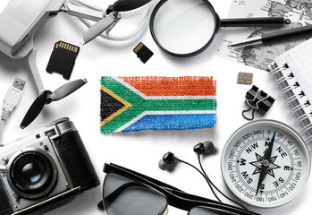 Flag of South Africa and travel accessories on a white background.