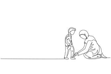 One single line drawing of young Islamic mom help her son to tie shoelace before go to the school vector illustration. Happy Arabian muslim family parenting concept. Modern continuous line draw design