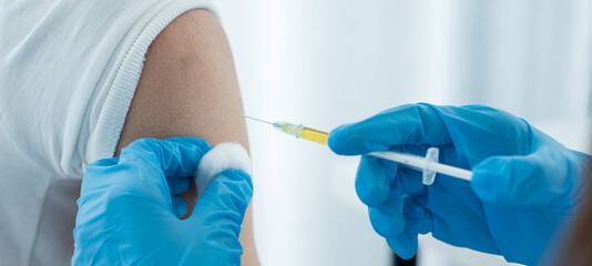 Female doctors vaccinated with syringes to prevent epidemics at hospitals, health care, and medical...
