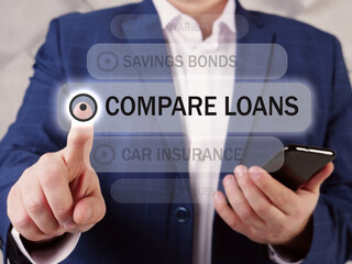  COMPARE LOANS inscription on the screen. Close up Loan officer hands holding black smart phone. A comparison rate includes the interest rate as well as certain fees and charges relating to a loan.