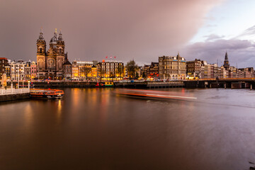 Fototapeta na wymiar Night cityscape in Amsterdam harbor in Netherlands