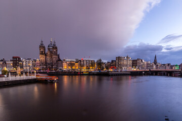 Night cityscape in Amsterdam harbor in Netherlands