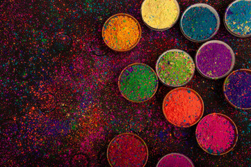 Holi color powder. Organic Gulal colors in bowl for Holi festival, Hindu tradition festive. isolated on black background