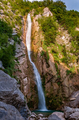 Fototapeta na wymiar High waterfall in Julian Alps.