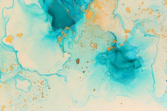 art photography of abstract fluid art painting with alcohol ink, blue and gold colors © tomertu