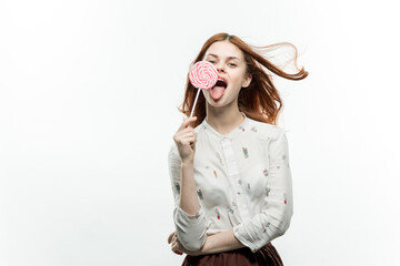 woman holding a round lollipop in her hands emotions sweets 