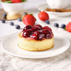 Delicious cake with fruits on background