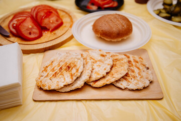 Chicken burger cutlets on wooden board