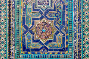  Beautiful floral and geometric traditional blue and turquoise tile decoration on facade of medieval mausoleum at Shah-i-Zinda necropolis in UNESCO listed Samarkand, Uzbekistan