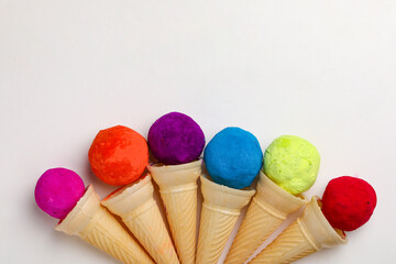 colors in shapes of ice cream scoops in cones for Indian holi festival