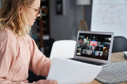 Young Female Teacher Teaching Remotely At Home