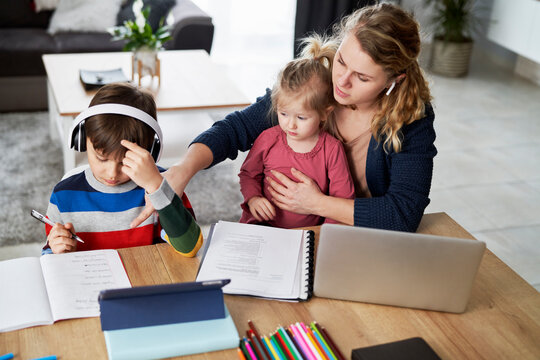 Mother During Home Office And Helping Children In Education