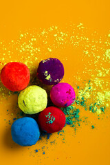 Celebrate indian festival holi, Multicolors ball on yellow background