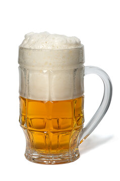 Glass mug with foamy beer isolated with shadow on white background close-up. Glass of cold golden beer with white bubble foam. Good for pub menu icon. Chill drink for a hot day A lot of foam with beer