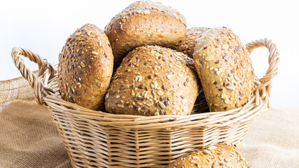 Rustic rye. Fresh loaf of rustic traditional bread with wheat grain ear or spike plant on linen texture background. Bakery with crusty loaves and crumbs. Design element for bakery product label.