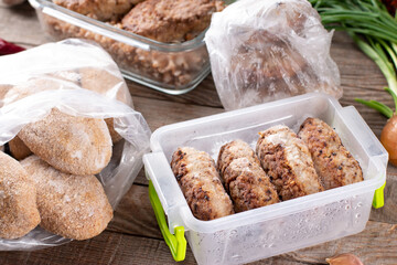 Frozen cutlets or meatballs in plastic bag on a table, ready to eat
