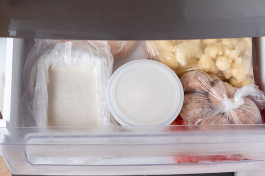 Frozen Broth In A Container In The Freezer