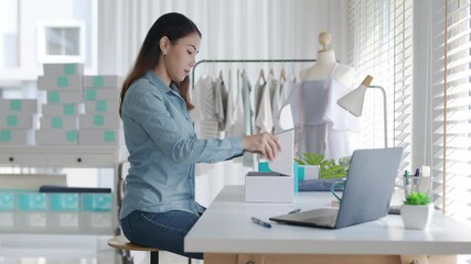 Young attractive beautiful hipster asia female packing product small business parcel order online retail store for delivery to customer. SME owner work preparing dropshipping box at home office.