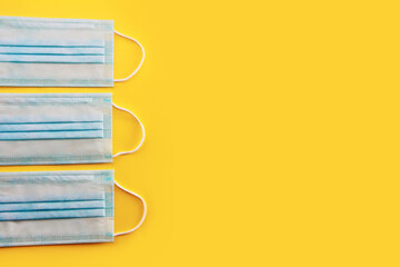 blue medical masks on a yellow background