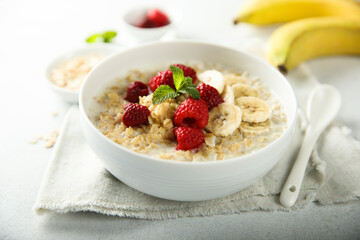 Healthy oatmeal porridge with fresh raspberry