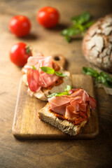 Homemade bruschetta with smoked meat and red pesto