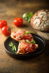 Homemade bruschetta with smoked meat and red pesto