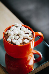 Orange cup with hot cocoa and marshmallows