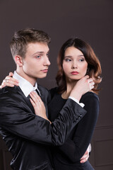 A young woman and young men in a romantic photo session, their love story.