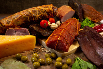 Assortment of cold cuts, a variety of processed cold meat products. On a wooden background