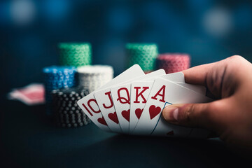 hand holding cards, poker chips casino background 