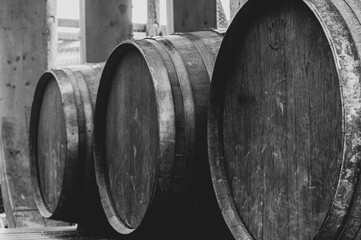 Abstract black and white view of three wooden barrels in row