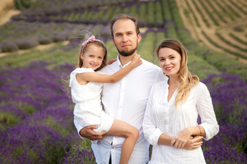 Beautiful family having fun in a lavender field