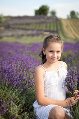 Cute girl having fun in a lavender field