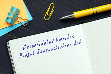  Juridical concept about Consolidated Omnibus Budget Reconciliation Act with inscription on the piece of paper.