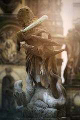 Statue of Hercules standing on a fountain in Olomouc. In the background, the column of the Holy Trinity, written in UNESCO