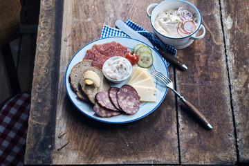 Appetizing antipasti with fresh vegetable slices on rustic table