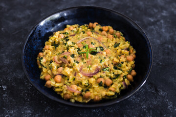 vegan chickpea potato spinach curry with almonds and onions, healthy plant-based food