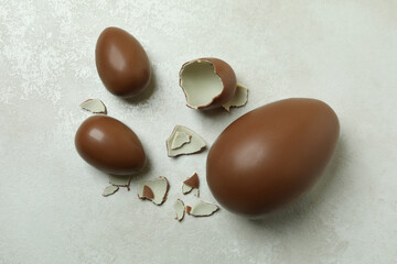 Easter chocolate eggs on white wooden background